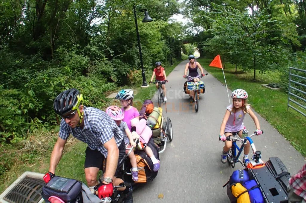 A group of people enjoying a family bike ride on a park trail.