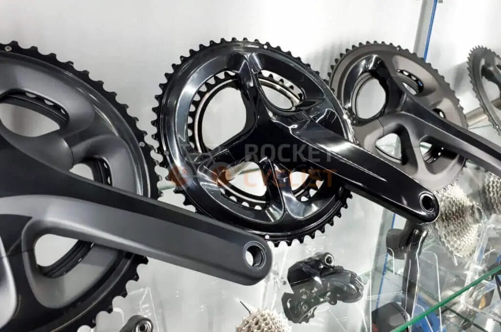 Shimano cranksets on display in a store.