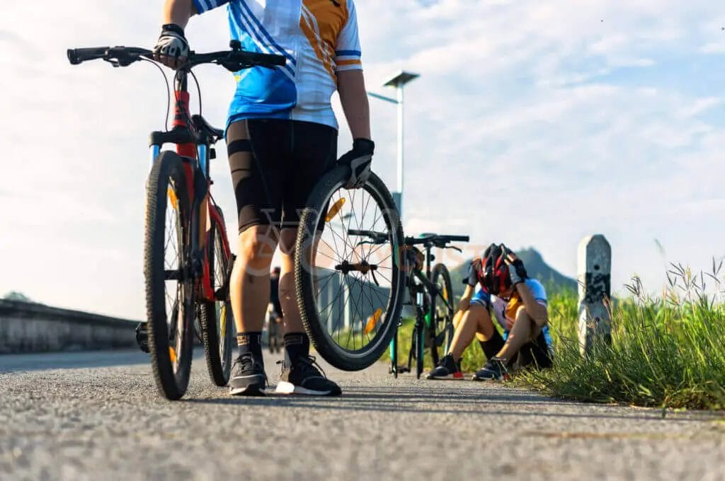 Two people standing next to their bicycles.