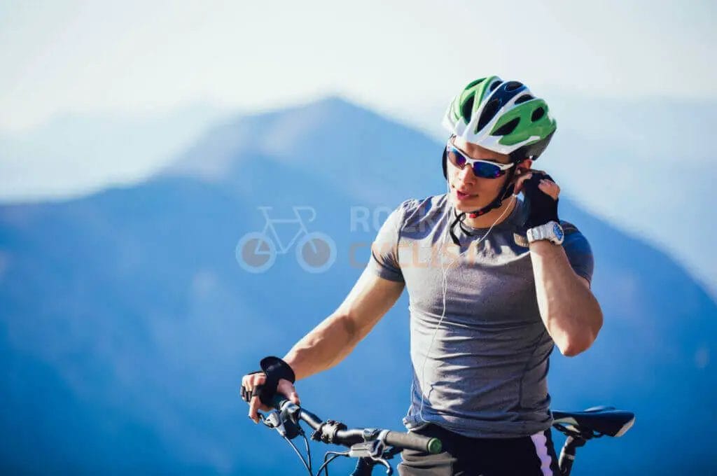 A man on a mountain bike talking on his cell phone.