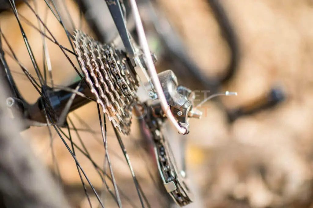 A close up of a bicycle's chain and gears.