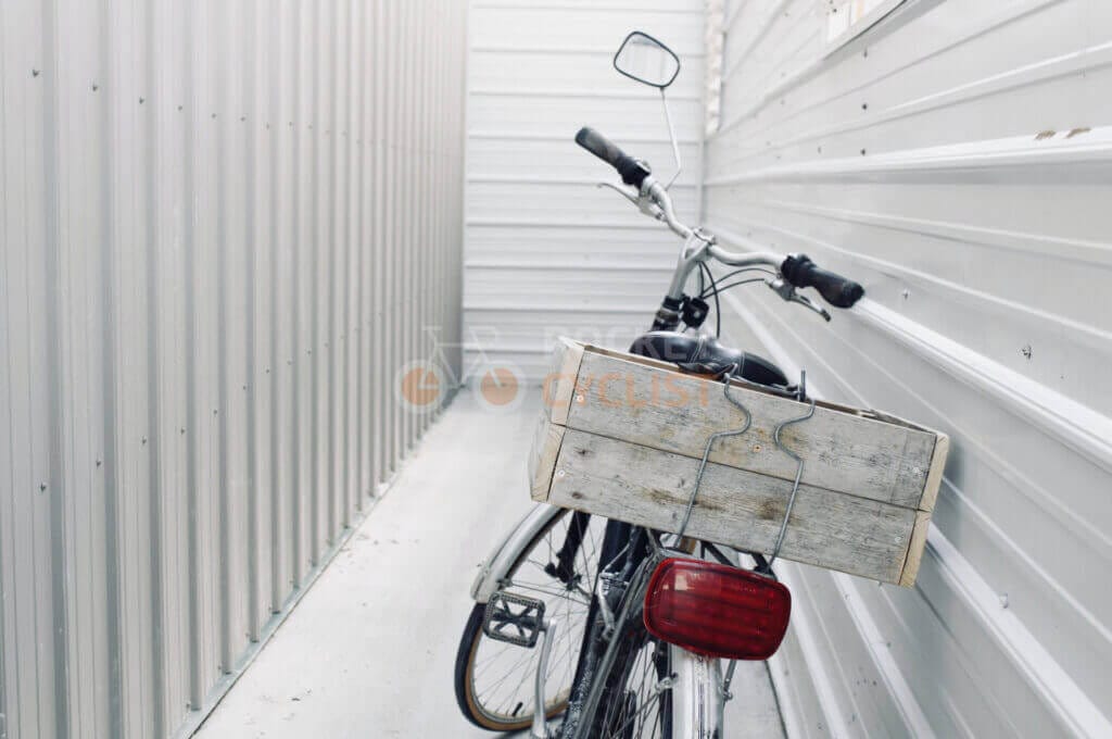 A bicycle is parked in a storage room.