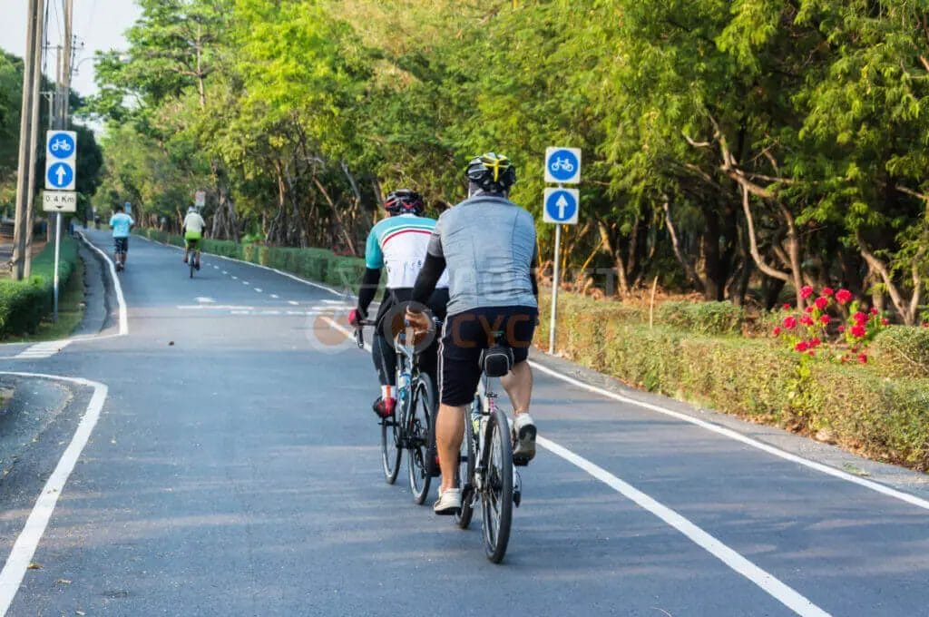 A group of people riding bicycles on a road.