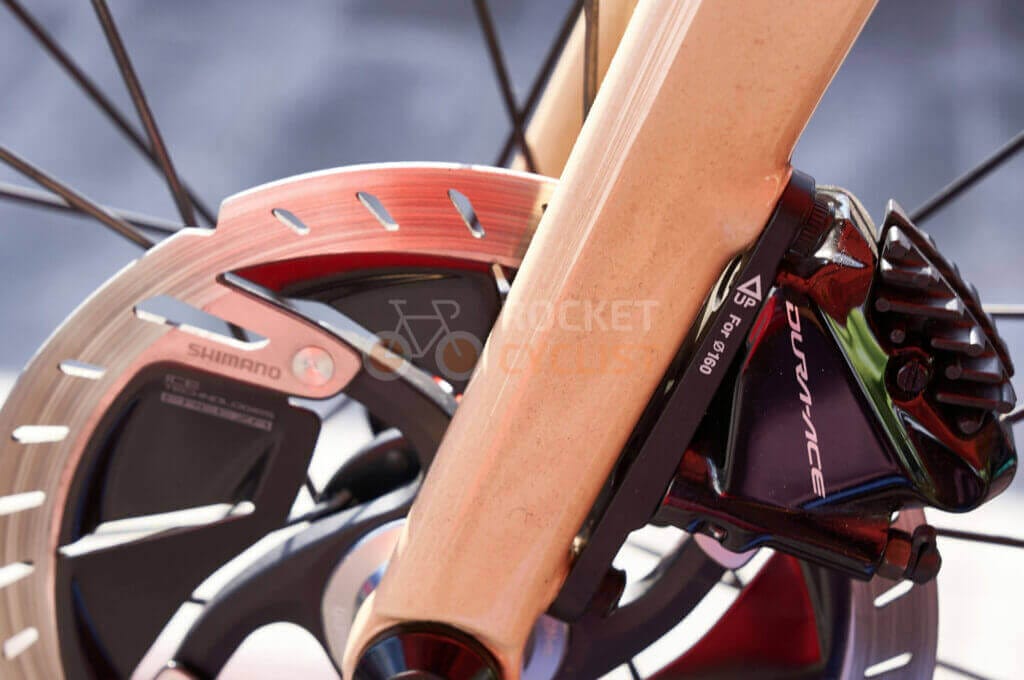 A close up view of a bicycle's brake.