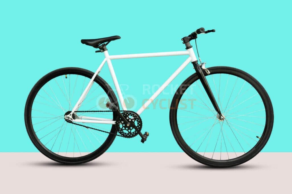 A white bike on a pink background.