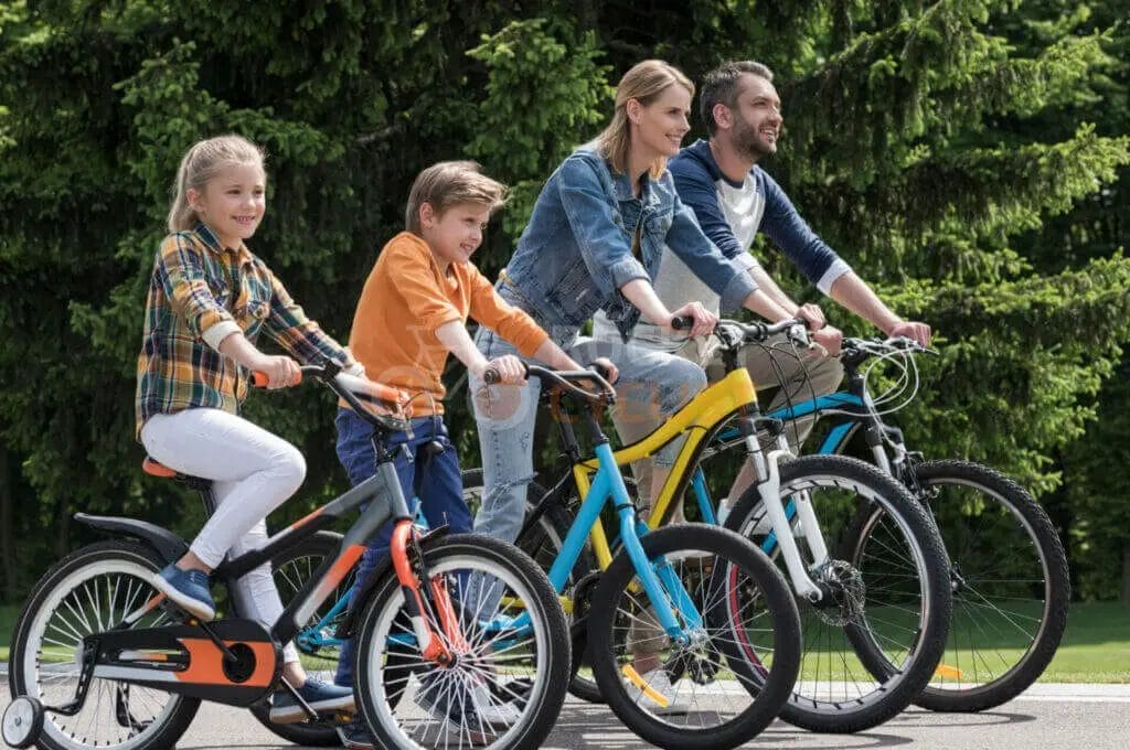 A family is riding bicycles in a park.