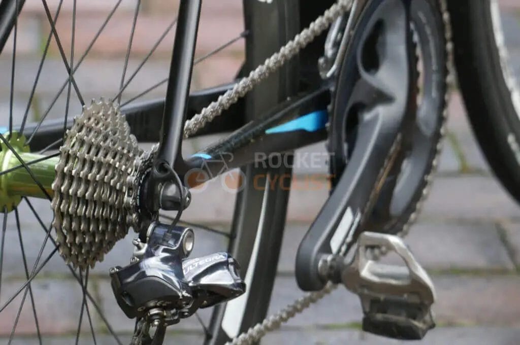 A close up of a bicycle chain and gears.