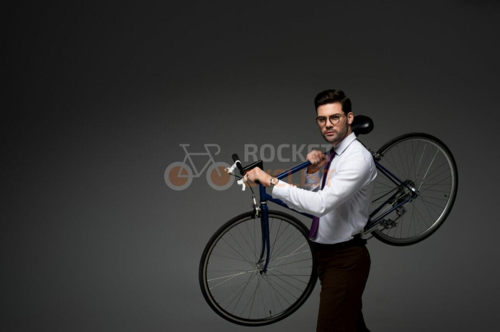 A man holding a bicycle.
