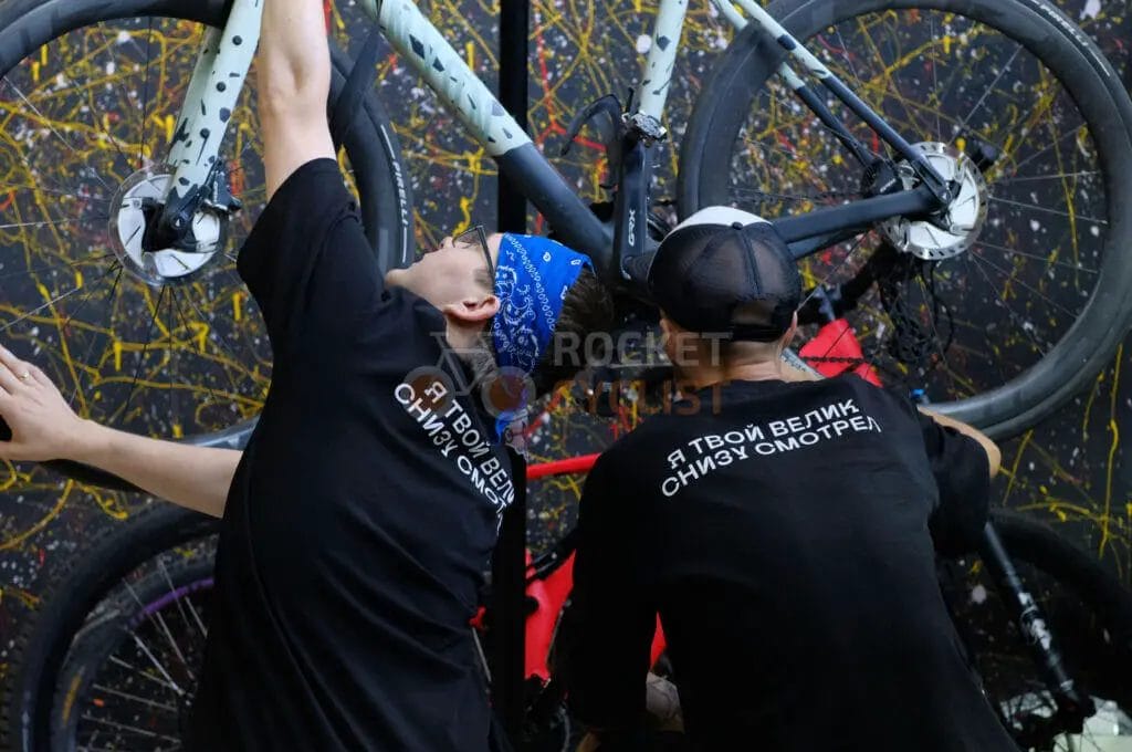 A group of men working on a bike.